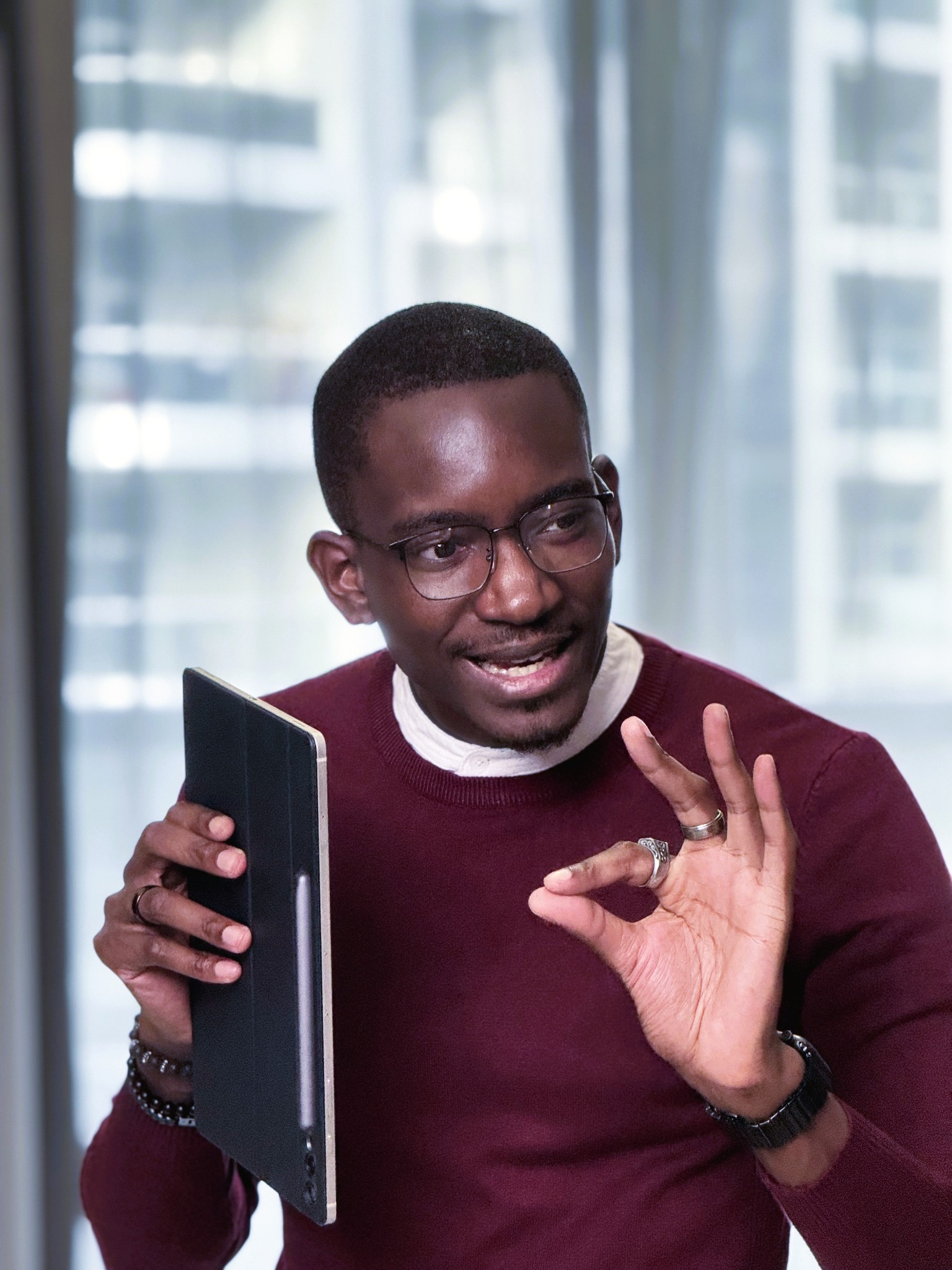 Azad Abdullahi discussing an idea while holding a tablet